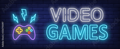 Video games neon text and gamepad with lightnings