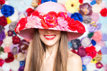 Elegant woman in a hat over floral background