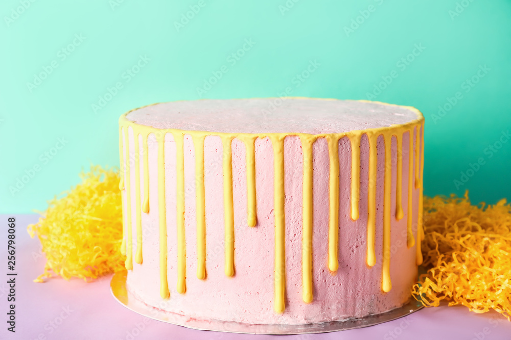 Tasty cake on color table