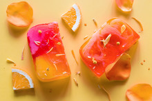 Homemade Natural Soap On A Yellow Background With Flower Petals