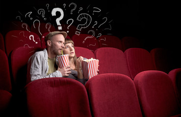 Wall Mural - Nice couple in cinema with drawn question signs around