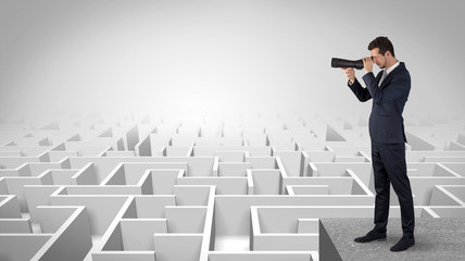 Wall Mural - businessman standing on maze and looking forward to the future concept
