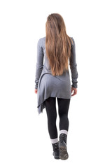 Wall Mural -  Back view of young stylish woman with long healthy hair walking away. Full body isolated on white background. 