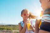 Children drinking orange juice outdoor