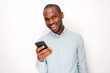 © mimagephotos - handsome young black man holding mobile phone against white background
