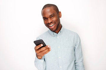 Wall Mural - handsome young black man holding mobile phone against white background