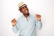 © mimagephotos - happy african american man with hat dancing against isolated white background
