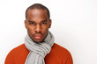 © mimagephotos - front portrait of handsome young black man with scarf posing against white background