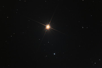 The Arcturus star in Boote constellation, called also apha Boo, taken with large diameter telescope in the dark space.