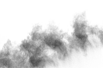 Wall Mural - black powder explosion against white background. charcoal dust particles exhale in the air.