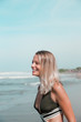 © mariiaplo - Beautiful caucasian woman in green bikini on tropical beach.