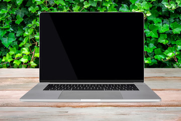 Wall Mural - green eco-friendly enviroment template - front view of a generic modern laptop with a black screen o