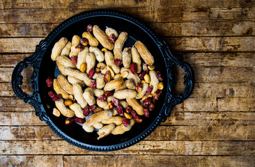 Wall Mural - Roasted peanuts in a shell on a plate