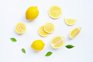 Wall Mural - Lemon and slices with leaves isolated on white.