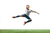 Fototapeta Sport - Young boy running and jumping isolated on white studio background. Junior football soccer player in motion