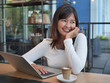 © chayathon2000 - Asian woman using laptop computer in coffee shop cafe