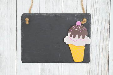 Wall Mural - Blank hanging chalkboard with ice cream cone on weathered whitewash textured wood background