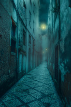  Narrow Old And Scary Street With Shabby, Dilapidated Houses And Dim Lanterns In A Medieval City At Night