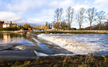 Water Flows Over A Manmade Weir On The River Severn In Shrewsbury, Shropshire, England.