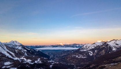 Sticker - A panoramic drone view of the Alps at sunset