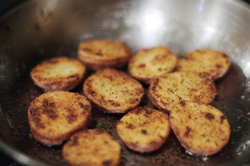 Wall Mural - Red potato potato chips cooking in a stainless steel pan.