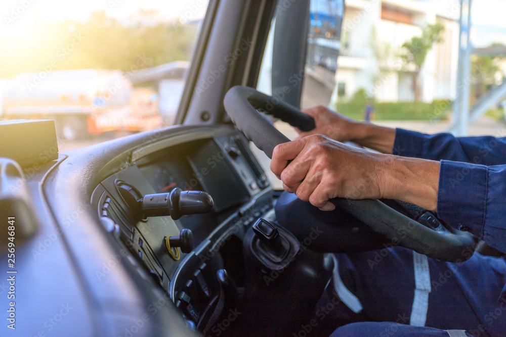 Truck driver keeps driving with hands - obrazy, fototapety, plakaty 