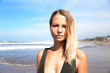 © mariiaplo - Beautiful caucasian woman in green bikini on tropical beach.