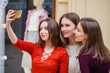 © Andrey_Arkusha - Happy young women take a picture of herself with a smart phone