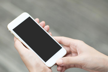 close up hand young woman in watching message on mobile smart phone during break. using cell phones to communicate in the online world. with blank or empty black screen 