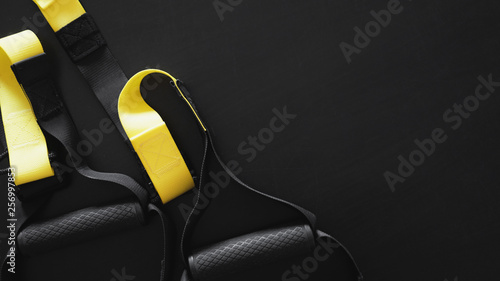 Black And Yellow Strap Functional Training Equipment On Grey
