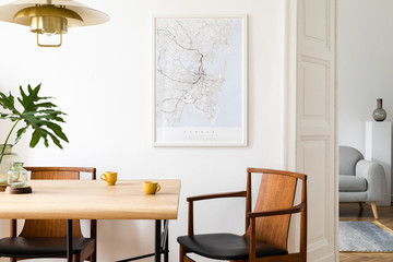 stylish and eclectic dining room interior with mock up poster map, sharing table design chairs, gold