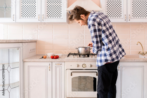 Young Happy Unmarried Single Man Bachelor Cooking At The Kitchen F Stock Photo Adobe Stock