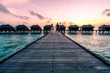 © nick - A couple enjoying a sunrise in the Maldives.