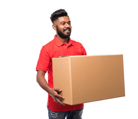 Wall Mural - Young indian delivery man standing with parcel post box isolated over white background.