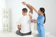 © New Africa - Doctor working with patient in hospital. Rehabilitation physiotherapy