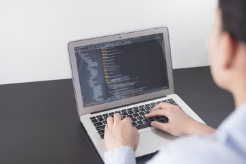 Young business woman programmer working at office. woman hands coding and programming on screen laptop, in programming concept, development web, developer, java developer, backend developer.