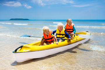 Wall Mural - Kids kayaking in ocean. Children in kayak in tropical sea