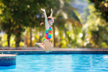 Wall Mural - Child in swimming pool on toy ring. Kids swim.