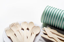 Wooden Single Use Kitchenware And Paper Cups And Plates On White
