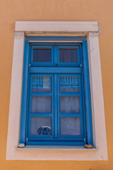 Typical blue window of a house in the town of Oia, on the island of Santorini