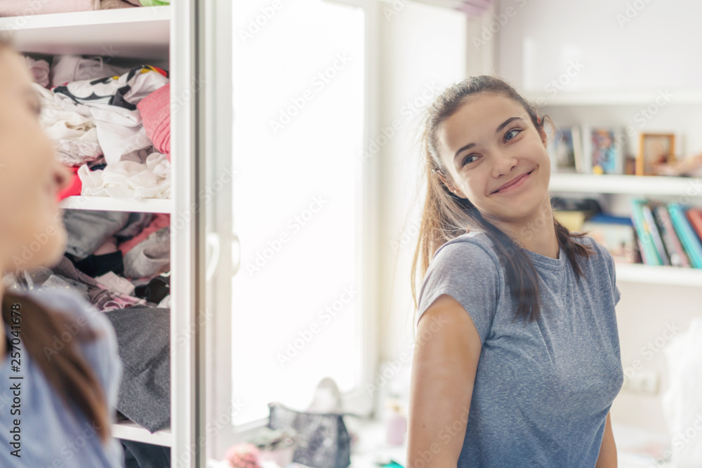 cute teen girl looks coquettishly at her reflection in the mirror Stock ...