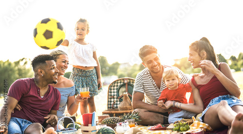 Happy multiracial families having fun together with kids at pic nic  barbecue party - Multicultural joy and