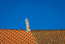 A Statue On The Tiled Roof