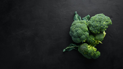 Broccoli. Fresh green broccoli on a black stone table. Top view. Free copy space.