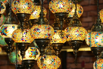 Wall Mural - Traditional bright decorative hanging Turkish lamps and colourful lights with vivid colours  in the Istanbul Bazaar, Turkey