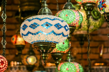 Wall Mural - Traditional bright decorative hanging Turkish lamps and colourful lights with vivid colours  in the Istanbul Bazaar, Turkey