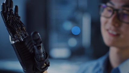 Leinwandbilder - Close Up of a Futuristic Prosthetic Robot Arm Being Tested by a Professional Development Engineer in a High Tech Research Laboratory with Modern Computer Equipment.