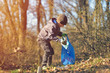 © Daniel CHETRONI - Recycle waste litter rubbish garbage trash junk clean training. Nature cleaning, volunteer ecology green concept. Young men and boys pick up spring forest at sunset. Environment plastic pollution