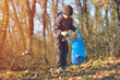 © Daniel CHETRONI - Recycle waste litter rubbish garbage trash junk clean training. Nature cleaning, volunteer ecology green concept. Young men and boys pick up spring forest at sunset. Environment plastic pollution