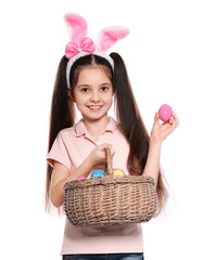 Sticker - Little girl in bunny ears headband holding basket with Easter eggs on white background